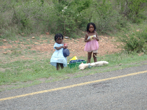 two little girls are dressed for church.